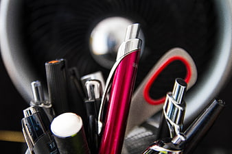 Close-up of colorful pens and scissors in office holder