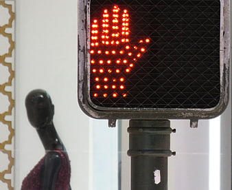 Red Don't Walk Traffic Signal with Blurred Mannequin Background