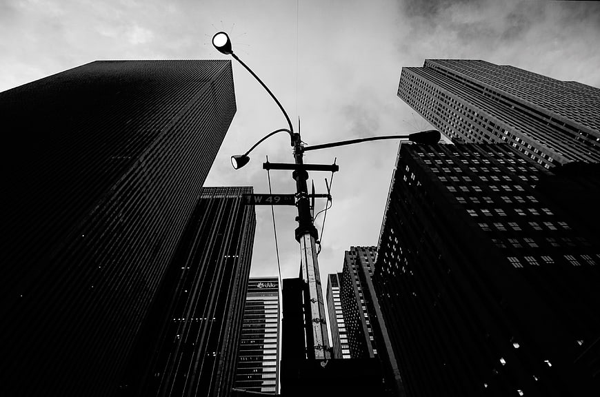 Low angle black and white skyscrapers and street lamp