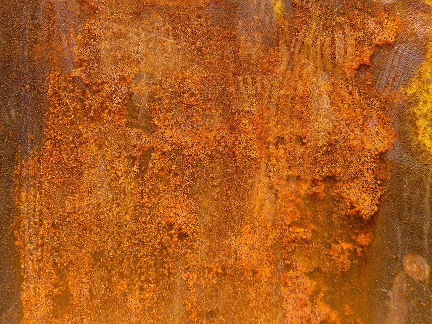 Close-up texture of rusty orange metal surface