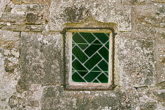 Small Green Stained Glass Window in Old Stone Wall
