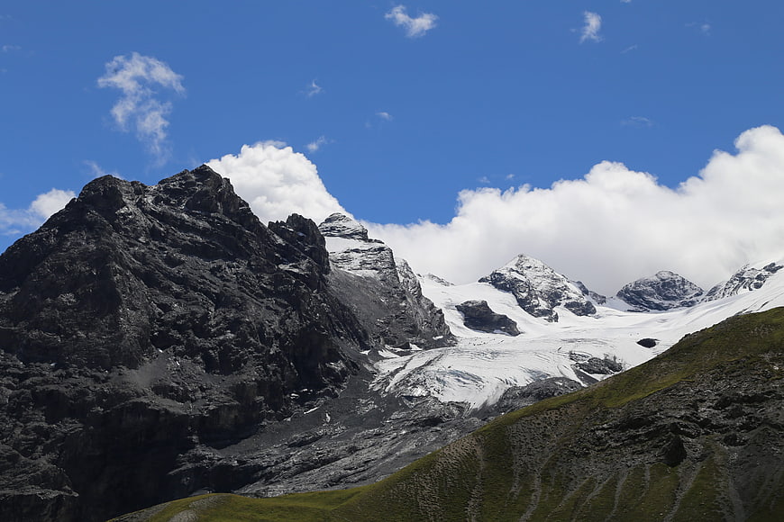 Majestic Alpine Peaks with Glacier and Blue Sky