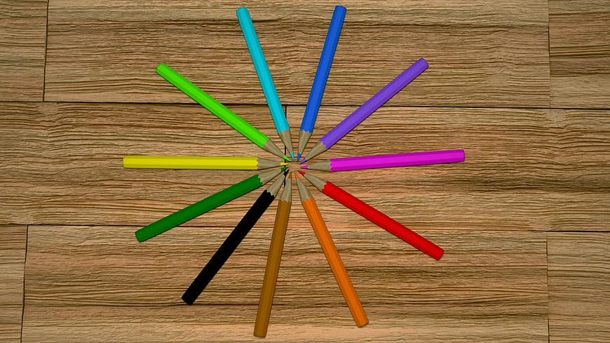 Colorful Pencils Arranged in a Circle on Wooden Floor