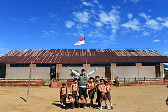 Indonesian Teacher and Students with National Flag at School