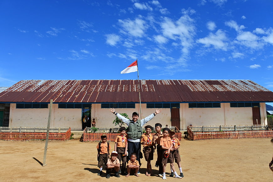 Indonesian Teacher and Students with National Flag at School
