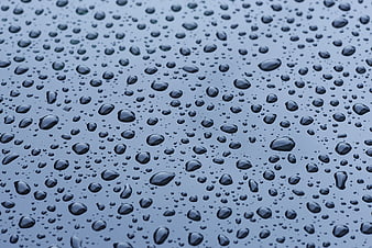 Close-up of water droplets on a smooth blue surface