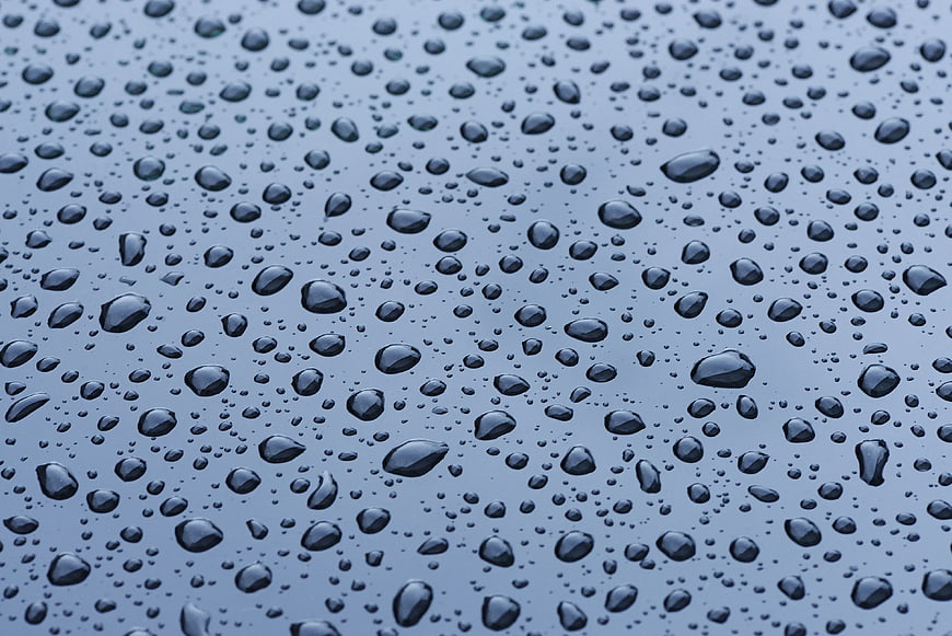 Close-up of water droplets on a smooth blue surface