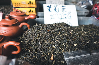 Loose leaf jasmine tea with clay teapots at market stall