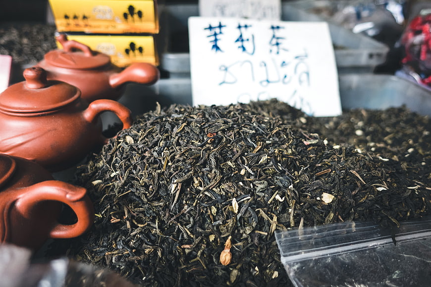 Loose leaf jasmine tea with clay teapots at market stall