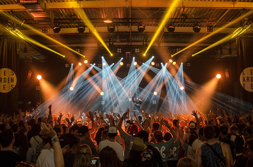Energetic Crowd at Live Concert with Dramatic Stage Lighting