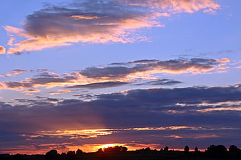Dramatic Sunset Sky with Pink and Orange Clouds over Silhouette
