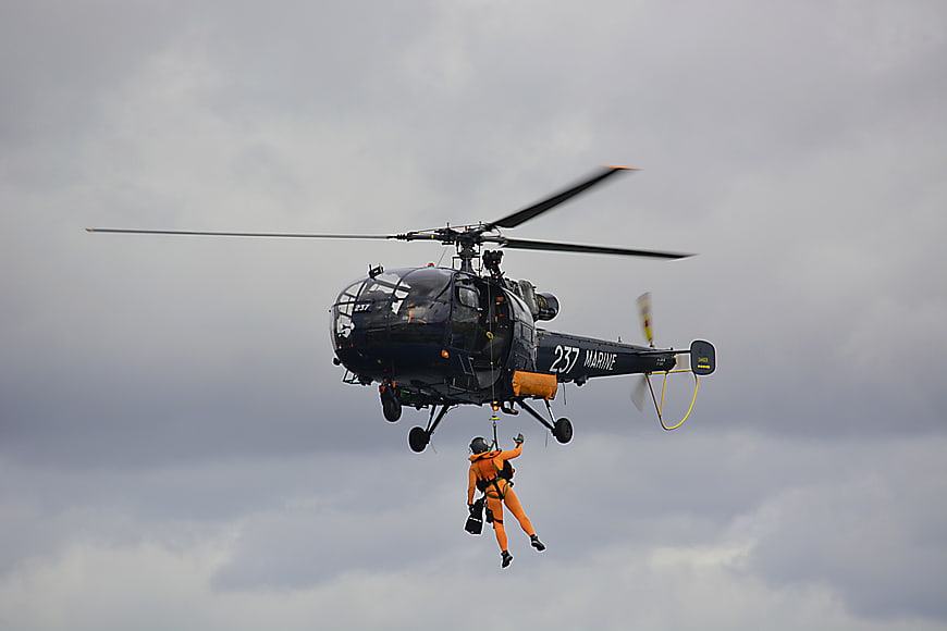 Marine helicopter rescue operation with rappelling personnel