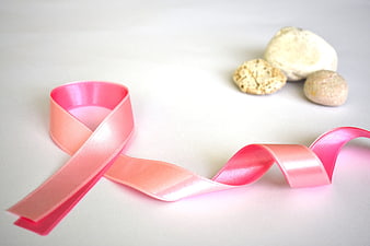 Pink Ribbon Awareness Symbol With Smooth Stones On White Background