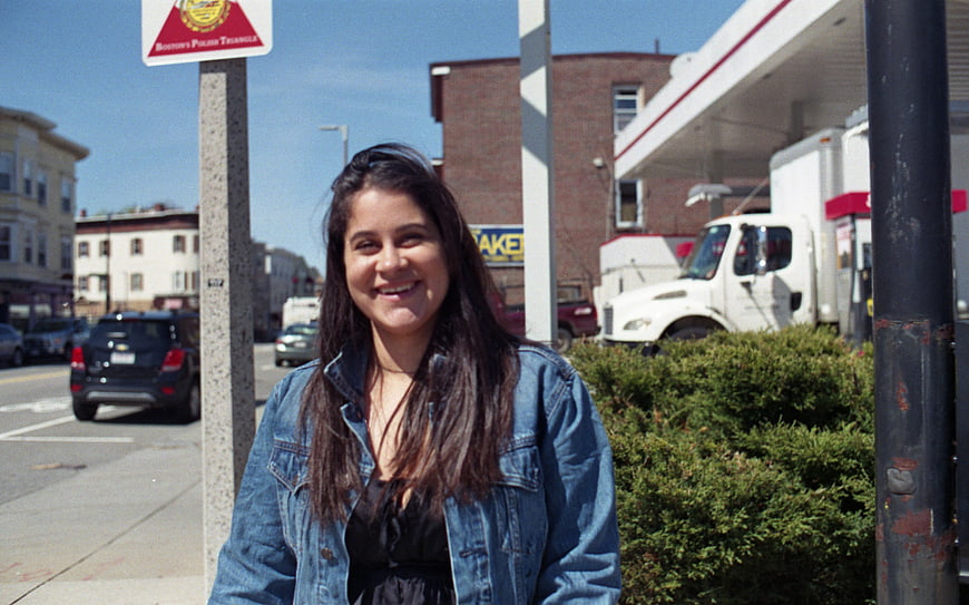 Smiling Brunette Woman in Denim Jacket on City Street