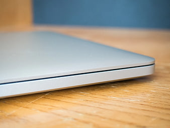 Close-up of Closed Silver Laptop on Wooden Desk