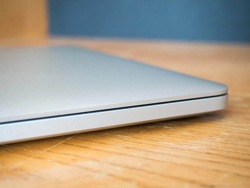 Close-up of Closed Silver Laptop on Wooden Desk