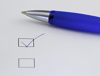Blue Ballpoint Pen Checking Box On White Paper Checklist