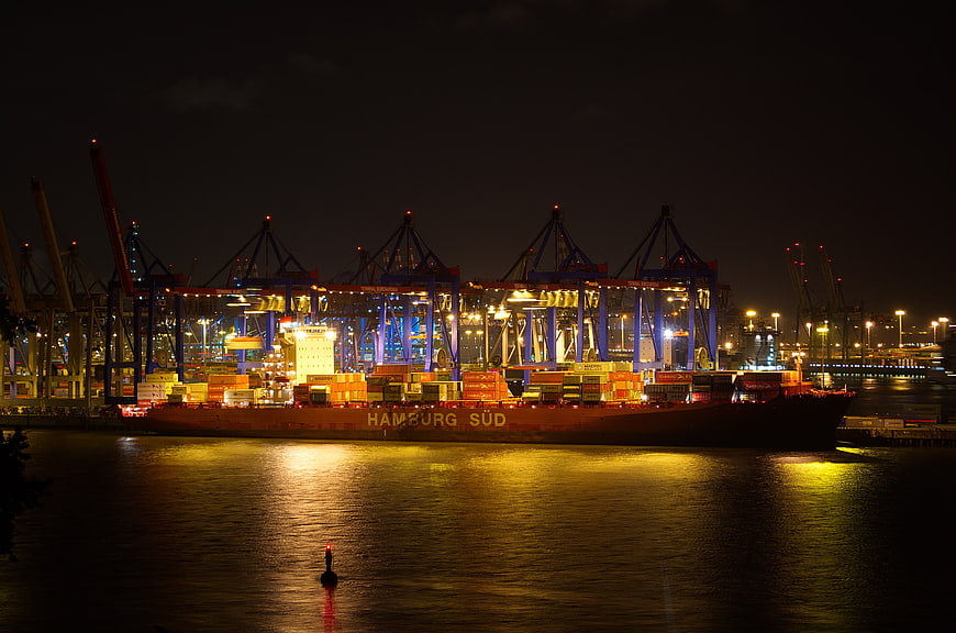 Hamburg Sud Cargo Ship At Night In Container Port