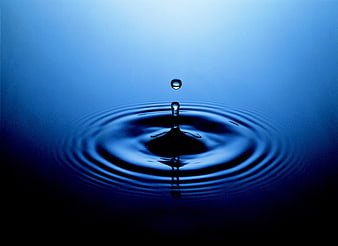 Blue Water Drop Splash with Ripples on Dark Background