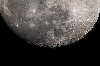 Close-up of the Moon's Cratered Surface Against Black Space