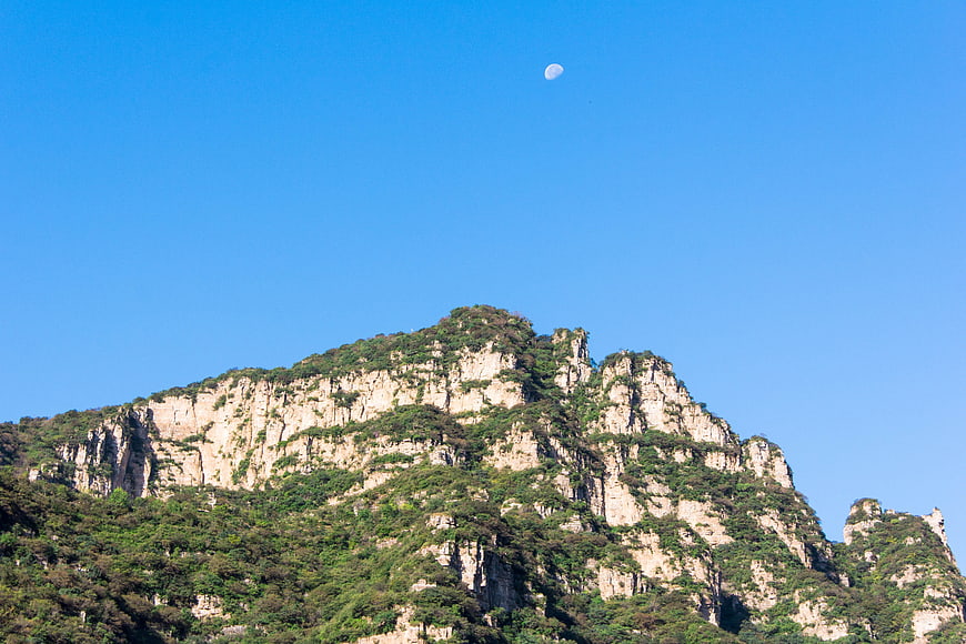 Wolf Teeth Mountain Landscape with Moon in Blue Sky