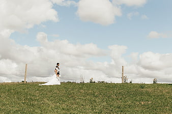 Bride and Groom Walking in Grassy Highland Landscape
