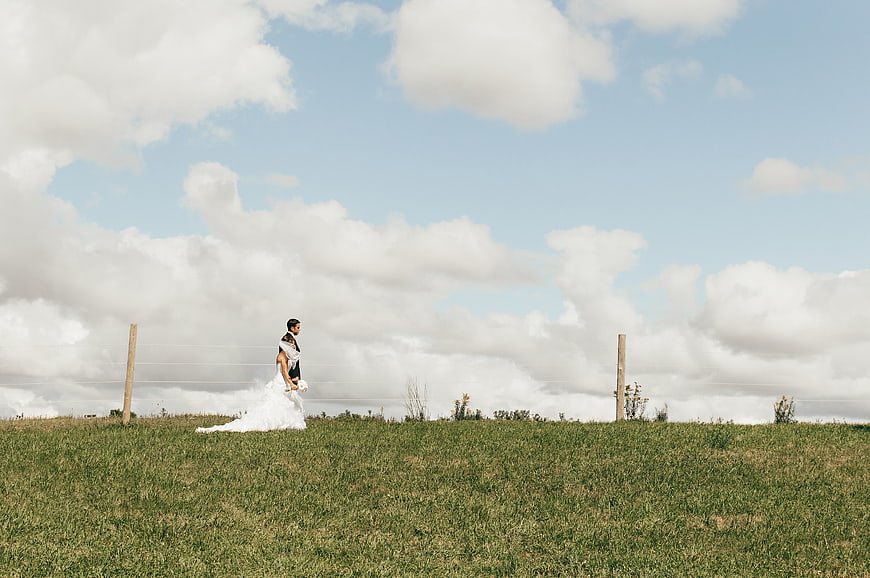 Bride and Groom Walking in Grassy Highland Landscape