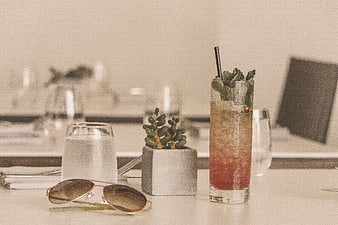 Refreshing cocktail and sunglasses on a restaurant table