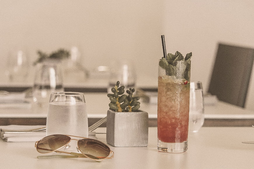 Refreshing cocktail and sunglasses on a restaurant table