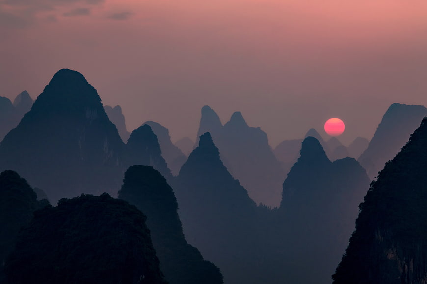 Sunset Over Misty Karst Mountains in Guangxi China