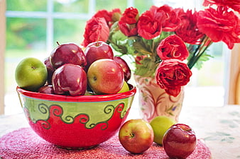 Colorful Bowl of Red and Green Apples with Red Flowers