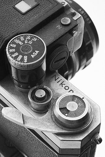 Close-up of vintage Nikon camera top dials and controls