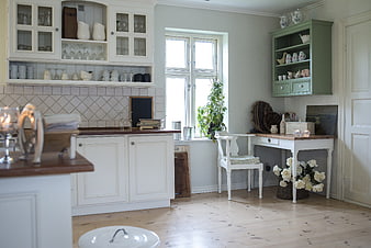 Bright Scandinavian Kitchen Interior With White Cabinetry And Green Accent