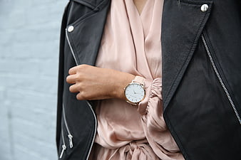 Woman wearing a minimalist watch with a black leather jacket