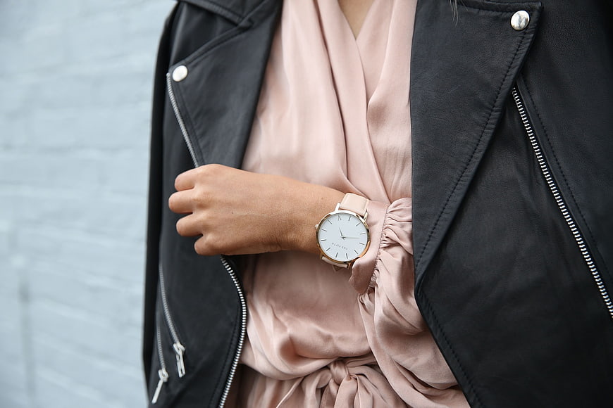 Woman wearing a minimalist watch with a black leather jacket