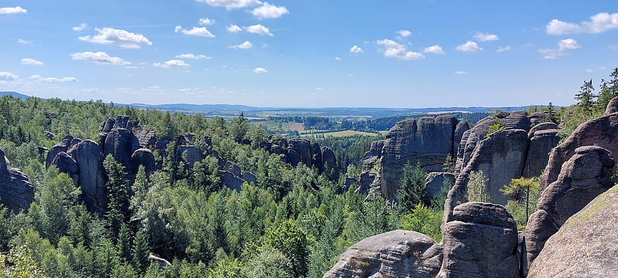 Panoramic view of dramatic sandstone rock formations in a lush green forest