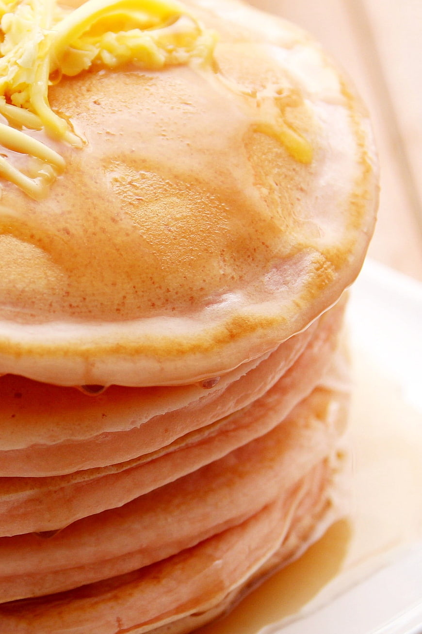 Close-up of fluffy pancakes with butter and syrup