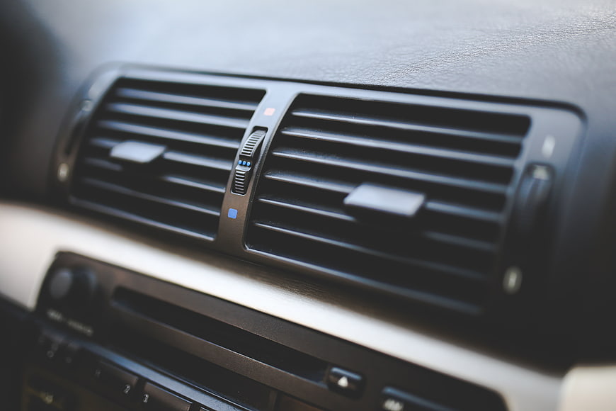 Close-up of car air conditioning vents and dashboard interior