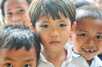 Close-up portrait of young school children looking at camera