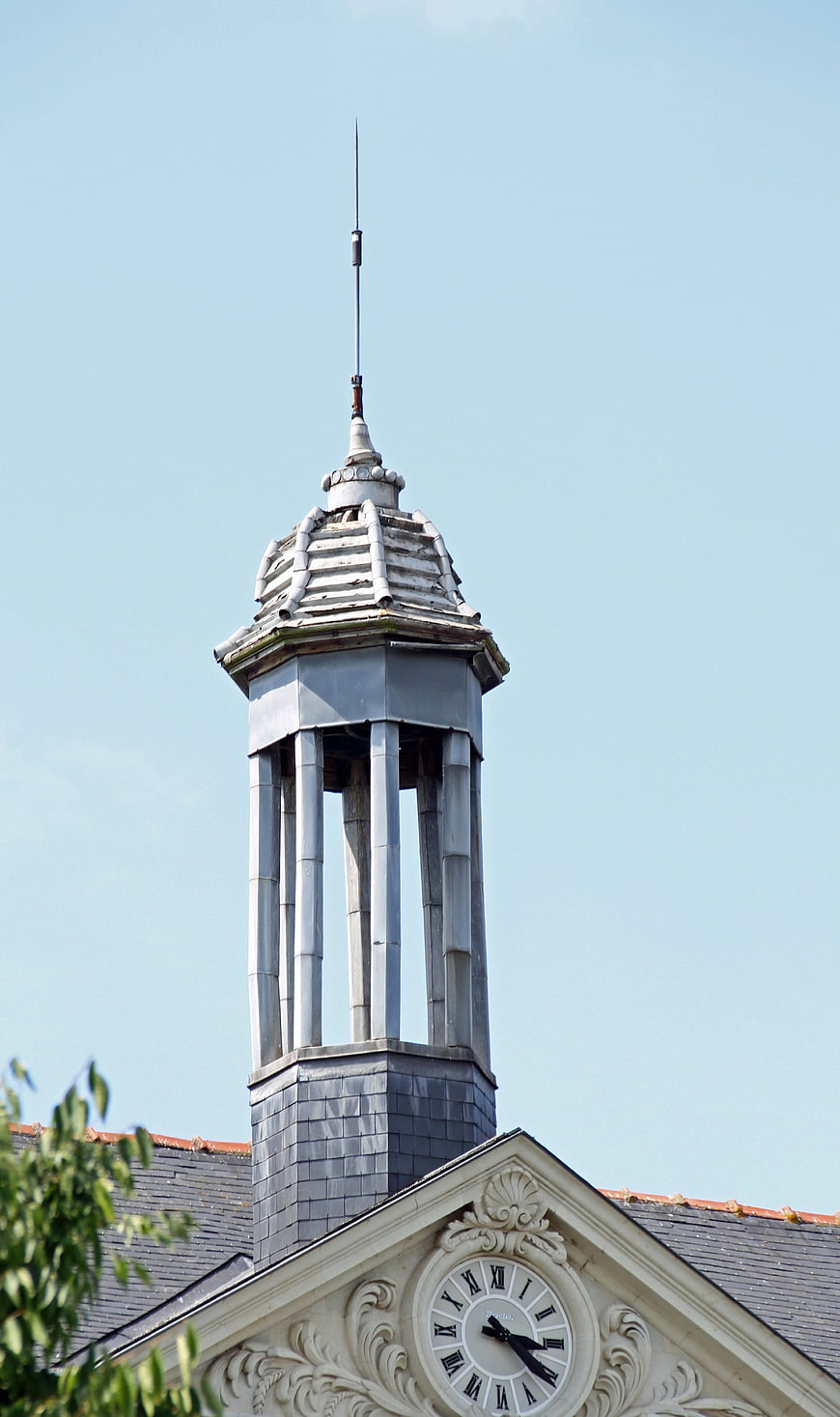 Historic church clock tower against blue sky