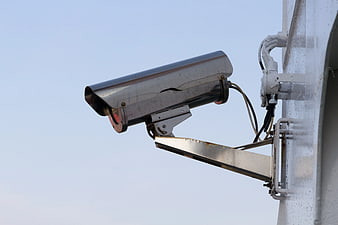 Silver Security Camera Mounted on Exterior Wall