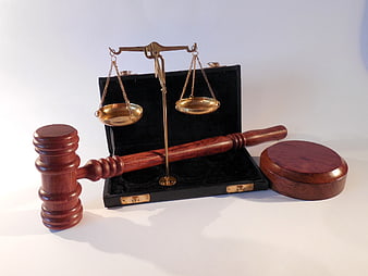 Wooden Gavel and Brass Scales of Justice on White Background