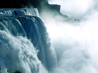 Majestic waterfall cascading into misty gorge