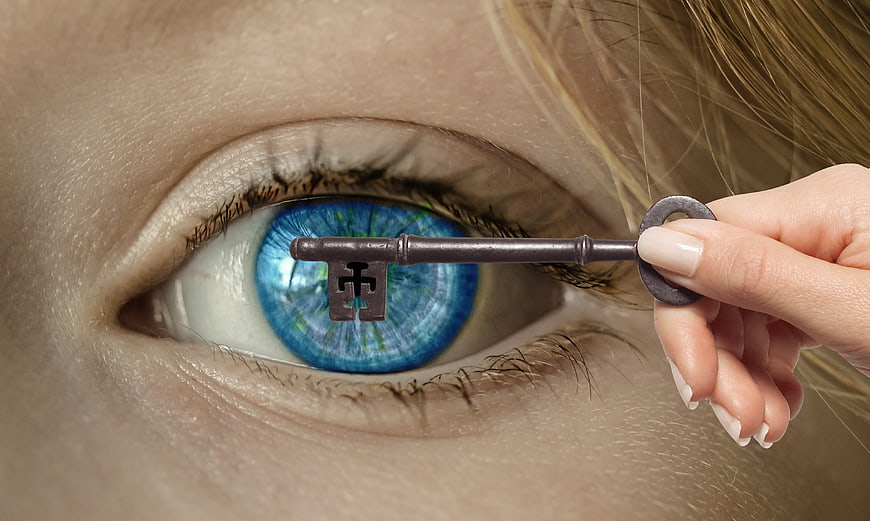 Conceptual Close-Up of Woman's Blue Eye With Vintage Key