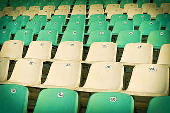 Rows of Empty White and Teal Stadium Seats