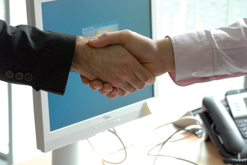 Close-up of business handshake in office setting