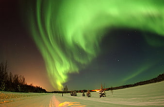 Vibrant Green Aurora Borealis Over Snowy Winter Road