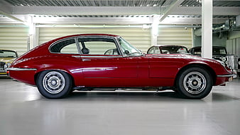Side Profile of Classic Red Jaguar E-Type in Garage