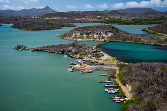 Aerial View of Turquoise Lagoon with Boats and Arid Hills