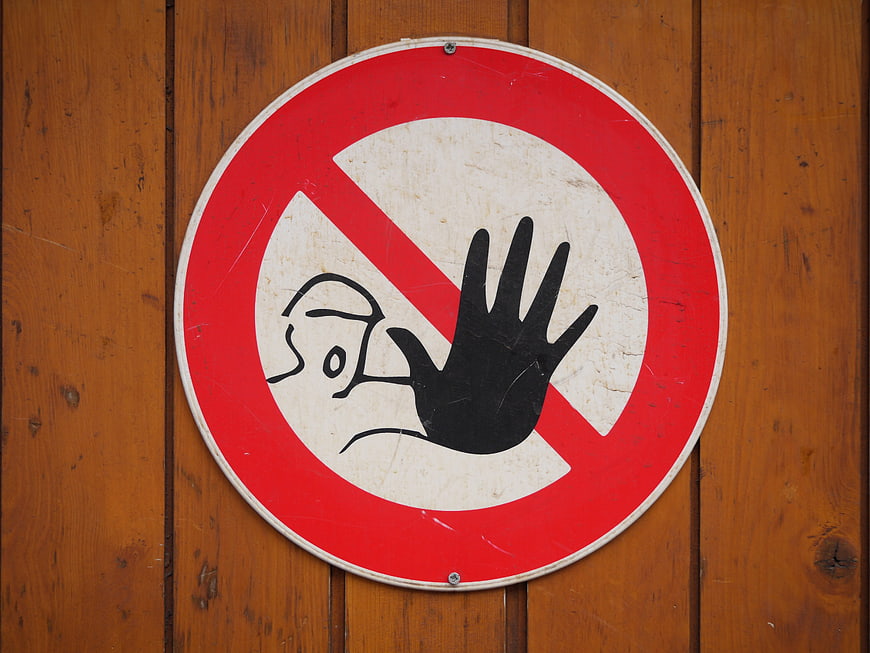 Hand-drawn stop hand symbol on red prohibition sign